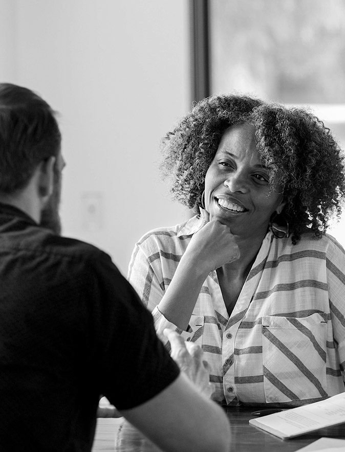 Mature businesswoman talks withe male colleague